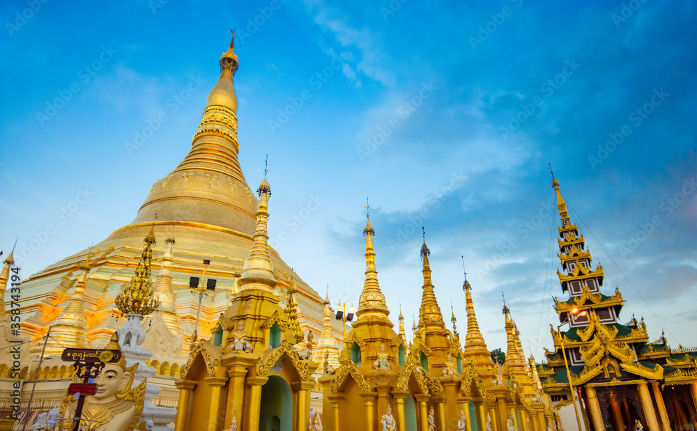 Naklejka premium YANGON,MYANMAR-MAY 15.2020: Buddhist Pilgrims in the Shwedagon Pagoda at night. It is the most sacred Buddhist pagoda for the Burmese.