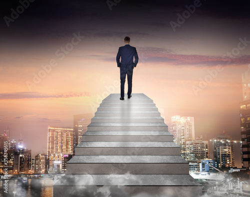 Man standing on top of stairs and looking at cityscape. Way to success © New Africa