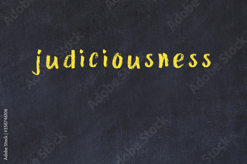 College chalk desk with the word judiciousness written on in