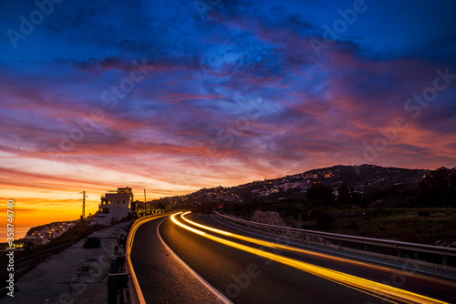 Luces nocturnas y trafico en la autovía de Salobreña al atardecer, provincia de Granada, Andalucía, España photo
