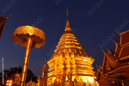 Golden pagoda at Wat Phra That Doi Suthep with beautiful twilight background. The popular tourist attraction in Chiang Mai, Thailand.