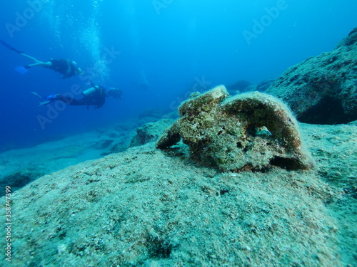 scuba diver underwater exploring ancient amphoras deep water history search ocean scenery