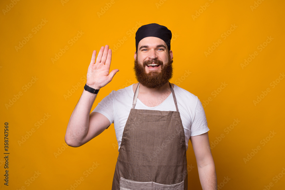 Fototapeta premium Photo of happy bearded Chef saluting everyone