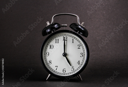 Wallpaper Mural An old alarm clock showing 5 o'clock on a black background Torontodigital.ca