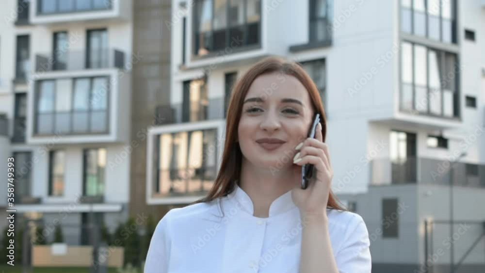 Beautiful stylish girl in white clothes talking on the phone portrait outdoor Beautiful stylish girl in white clothes talking on the phone portrait outdoor