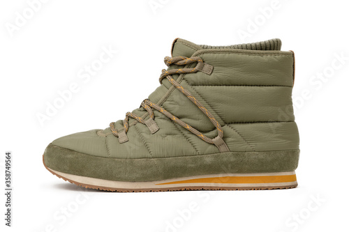 Trekking boot isolated on white background. Warm comfortable shoes with lacing. Light green boots or sneakers. Side view.