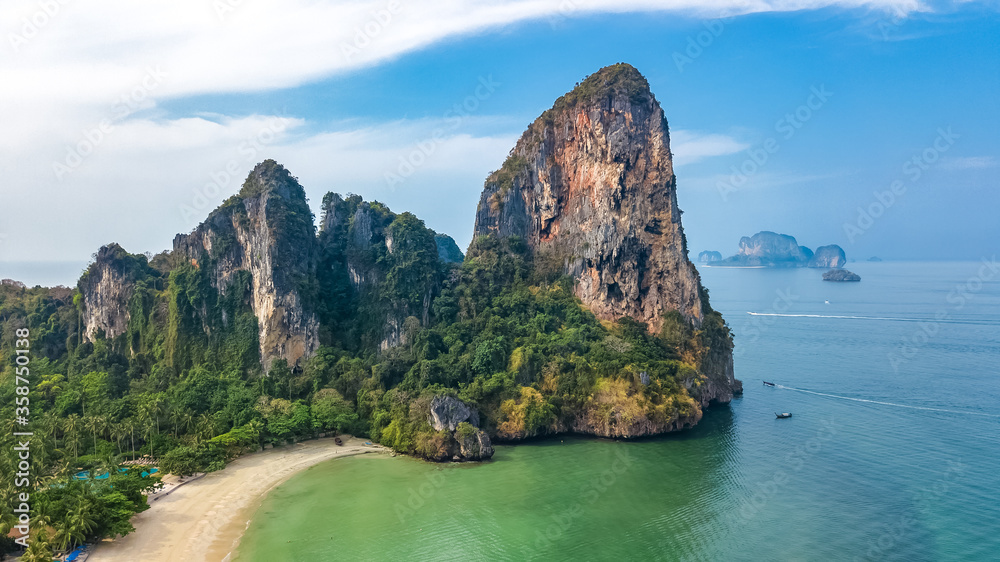Railay beach in Thailand, Krabi province, aerial bird's view of tropical Railay and Pranang beaches with rocks and palm trees, coastline of Andaman sea from above
