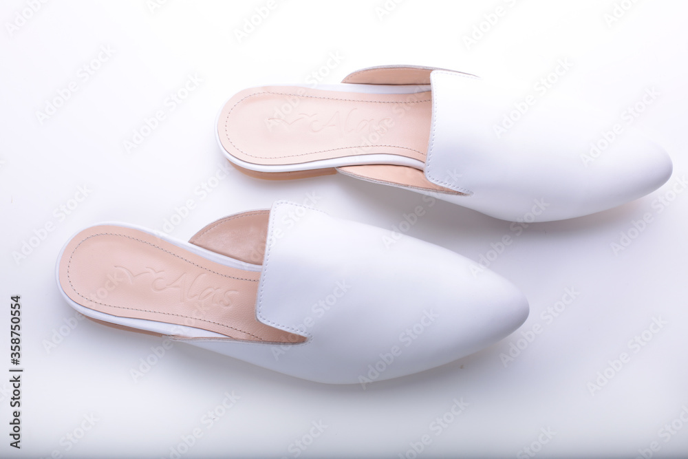 beautiful women's shoes on legs and layouts, leather white mules and loafers, in the interior of a room or office, a girl shoes, blue skirt and white shoes, a noble and elegant style, modern and trend beautiful women's shoes on legs and layouts, leather white mules and loafers, in the interior of a room or office, a girl shoes, blue skirt and white shoes, a noble and elegant style, modern and trend