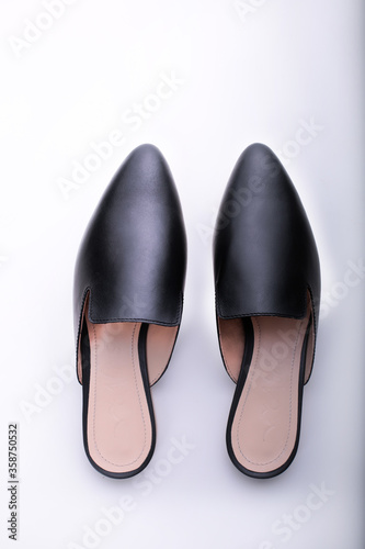 ballet shoes on a white background, black women’s flat shoes, classic, leather mules and loafers, leather substitute