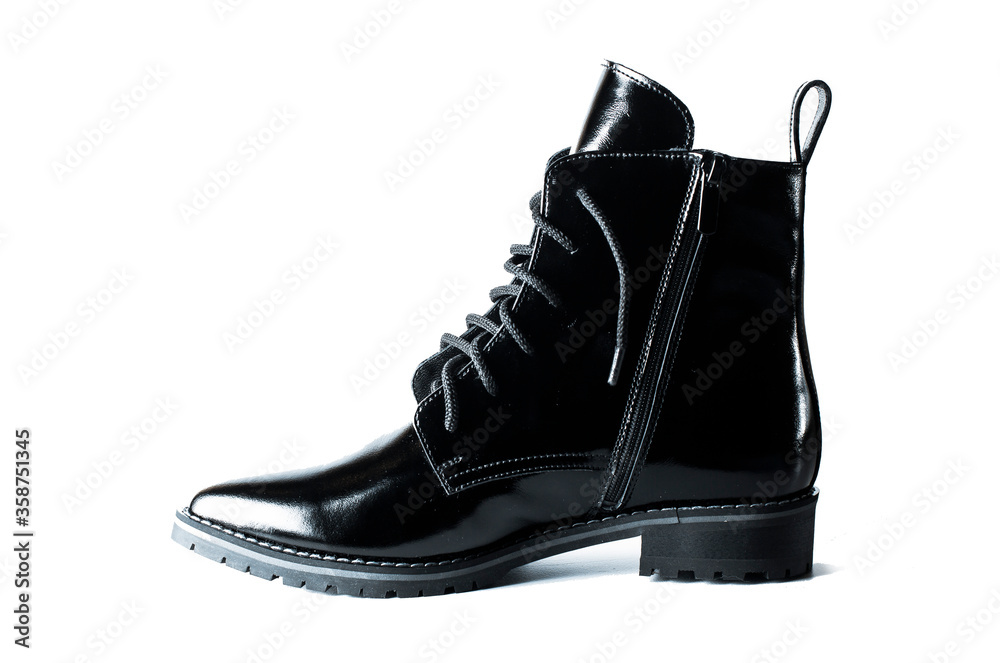 black patent leather autumn or spring boots on a white background isolated