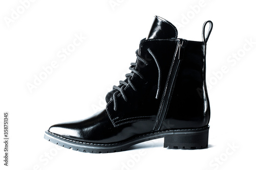 black patent leather autumn or spring boots on a white background isolated