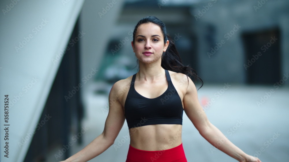 Athlete woman jumping on skipping rope. Sporty girl finishing cardio exercise