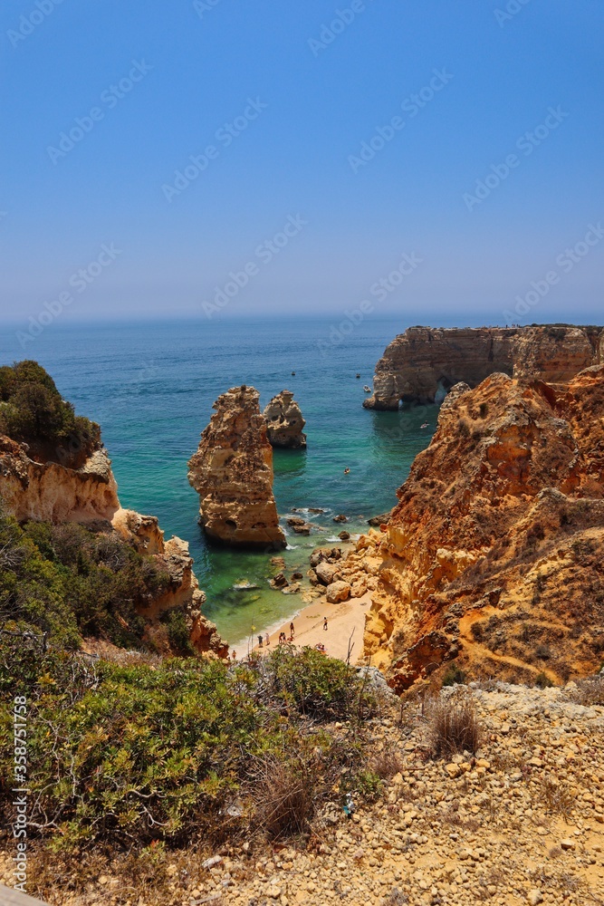 Top View Praia da Marinha in Algarve coast. Sandstone cliffs with turquoise Atlantic ocean.