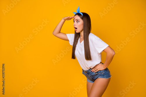 Profile side photo of astonished crazy girl look hand see incredible unbelievable ads scream wow omg wear blue headband isolated over vibrant color background