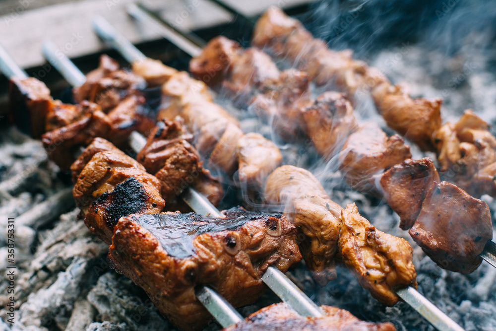 Skewers of pork ribs and chicken on skewers. Grilled meat. Cooking outdoors.. Skewers of pork ribs and chicken on skewers. Grilled meat. Cooking outdoors..