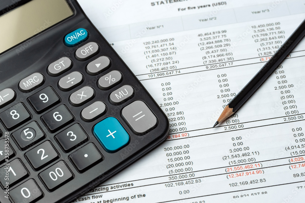 Pencil And Calculator On Financial Report - Business Accounting Concept Pencil And Calculator On Financial Report - Business Accounting Concept