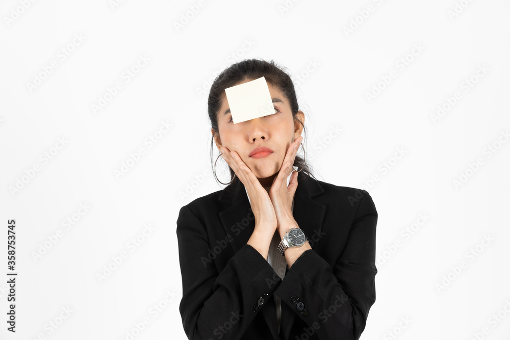 Exhausted tired young Asian business woman in formal wear with adhesive note on her forehead over white isolated background. Exhausted tired young Asian business woman in formal wear with adhesive note on her forehead over white isolated background.