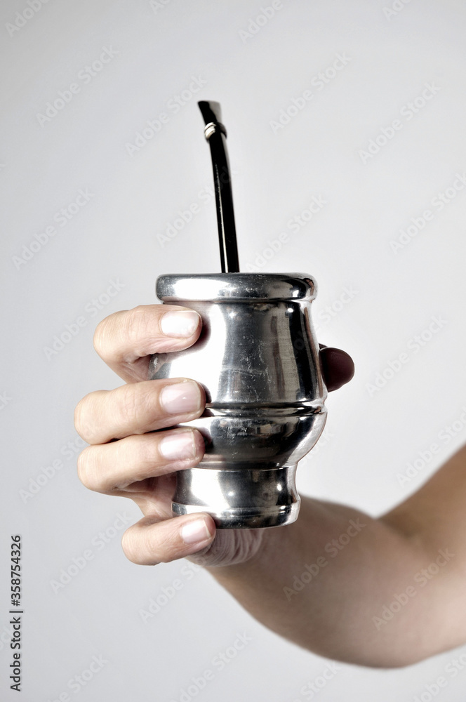 Obraz premium Hand and Yerba Mate on white background .