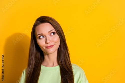 Portrait of minded inspired girl look copyspace think thoughts plan future holidays isolated yellow shine color background