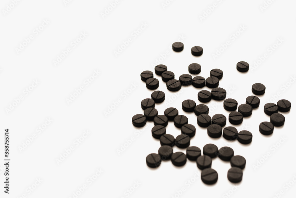 pills on white background, activated carbon on white background