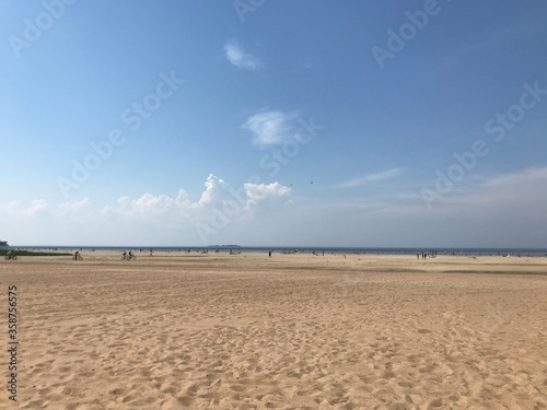  large sandy beach, people and the sea on a sunny day