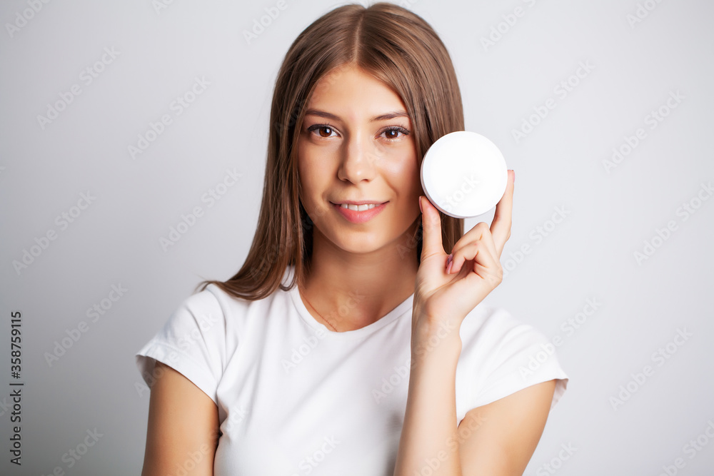 Skin care, woman with beauty face holding facial skin cream
