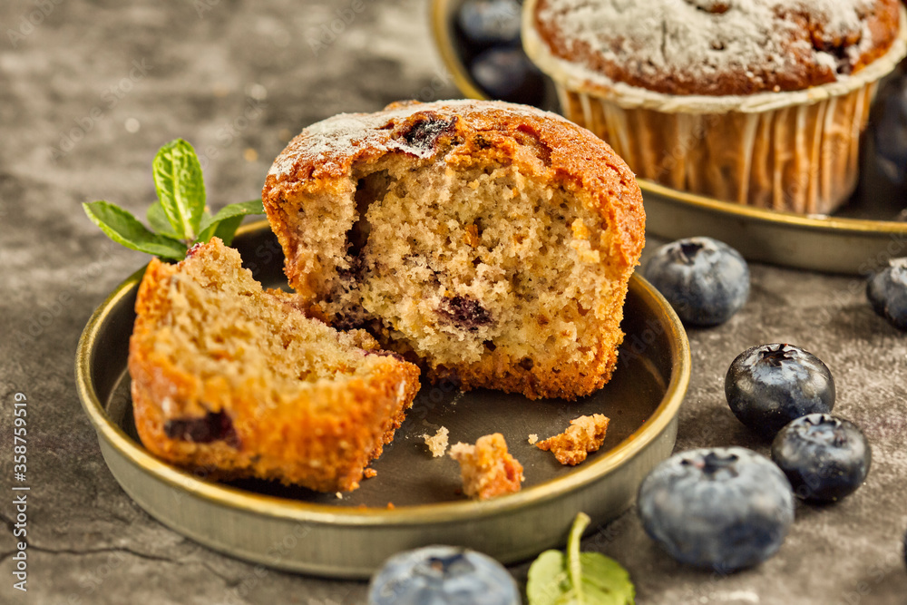 Freshly baked blueberry muffins. Cupcakes sprinkled with powdered Sugar.