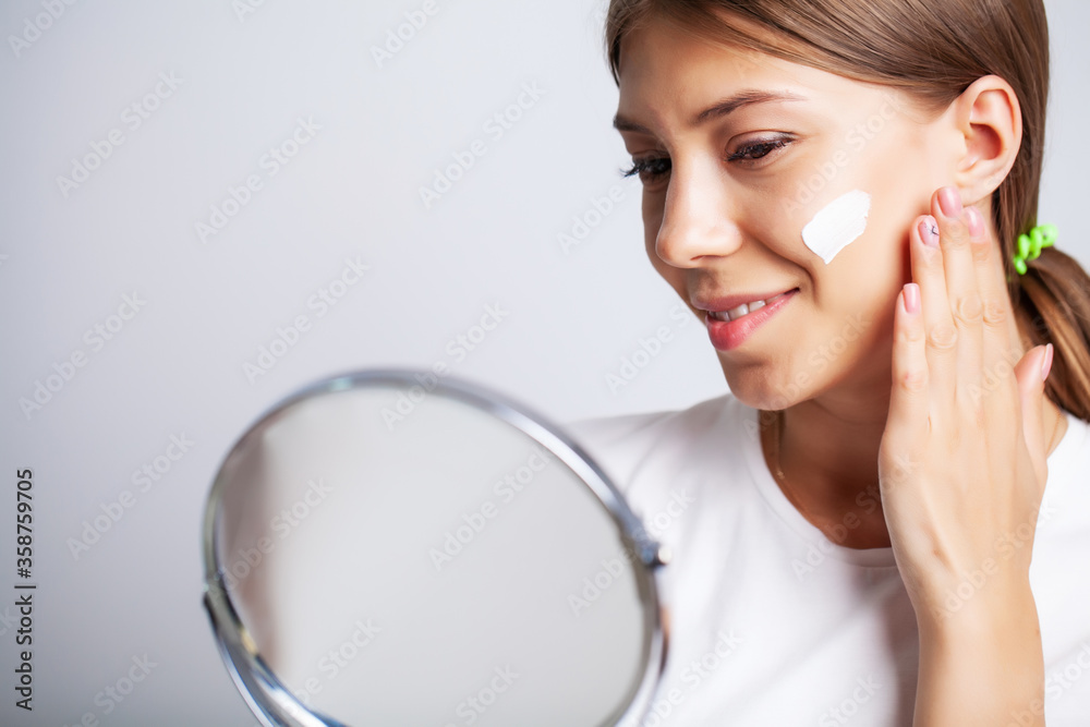 Skin care, young woman with beauty face use facial skin cream Skin care, young woman with beauty face use facial skin cream
