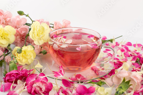 Pink Flower Tea with Carnation Petals. Hot Rose Drink in Glass Cup