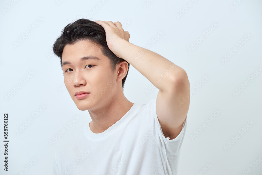 Smiling handsome Asian man in casual white t-shirt Smiling handsome Asian man in casual white t-shirt