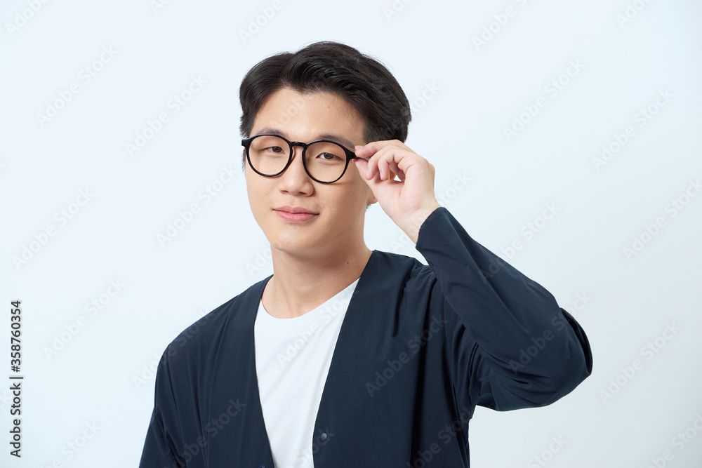 Portrait of friendly asian man wearing blue shirt, smiling Portrait of friendly asian man wearing blue shirt, smiling