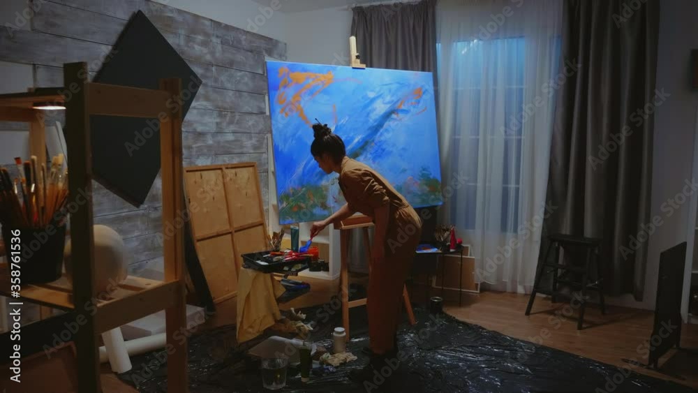 Successful artist painting impressionism art on large canvas in studio. Modern artwork paint on canvas, creative, contemporary and successful fine art artist drawing masterpiece Successful artist painting impressionism art on large canvas in studio. Modern artwork paint on canvas, creative, contemporary and successful fine art artist drawing masterpiece