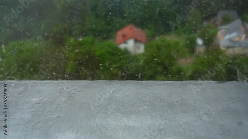 Raindrops drip onto the cornice. Slow motion.	 photo
