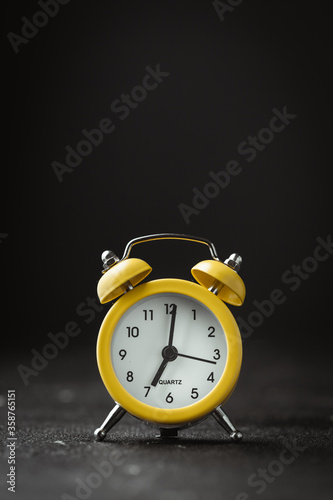 Wallpaper Mural Yellow vintage alarm clock on the black background. shallow depth of field Torontodigital.ca