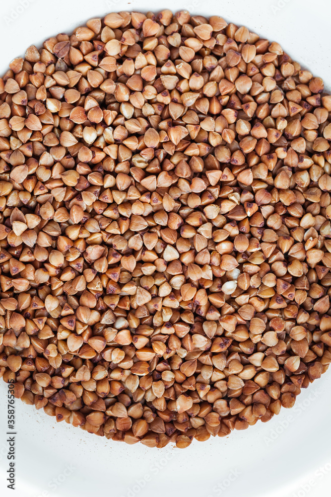 Fototapeta premium Macro overhead shot of buckwheat seeds as a background texture