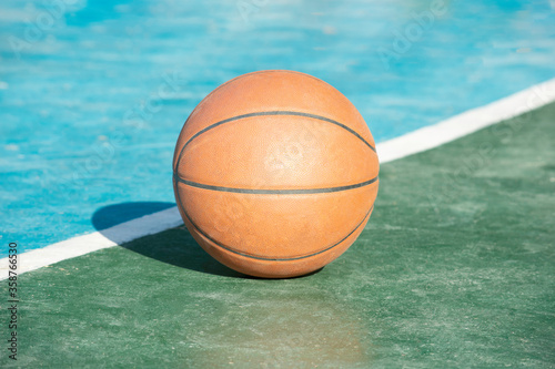 Basketball leather on Green and blue concrete ground.