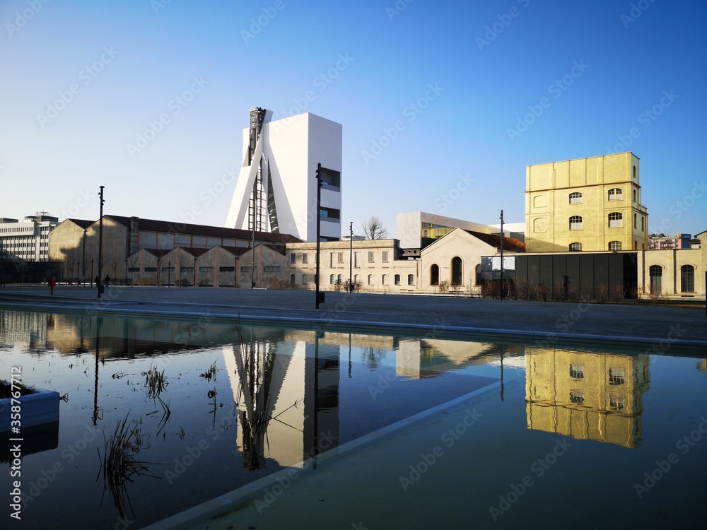 Fototapeta premium Milan, Italy February 17th 2019 Fondazione Prada with reflective pool, photographed from Adriano Olivetti's square
