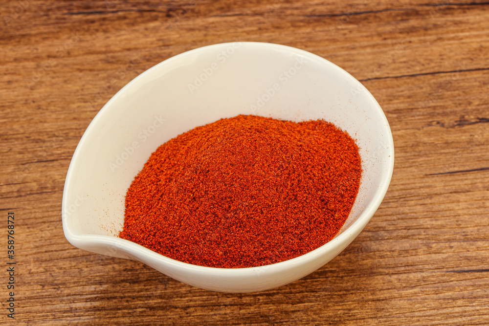 Dry paprika powder in the bowl Dry paprika powder in the bowl