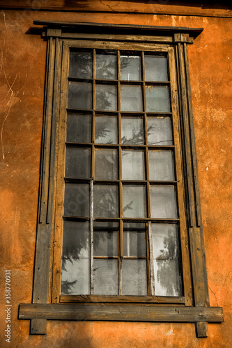 large antique window with an unusual frame