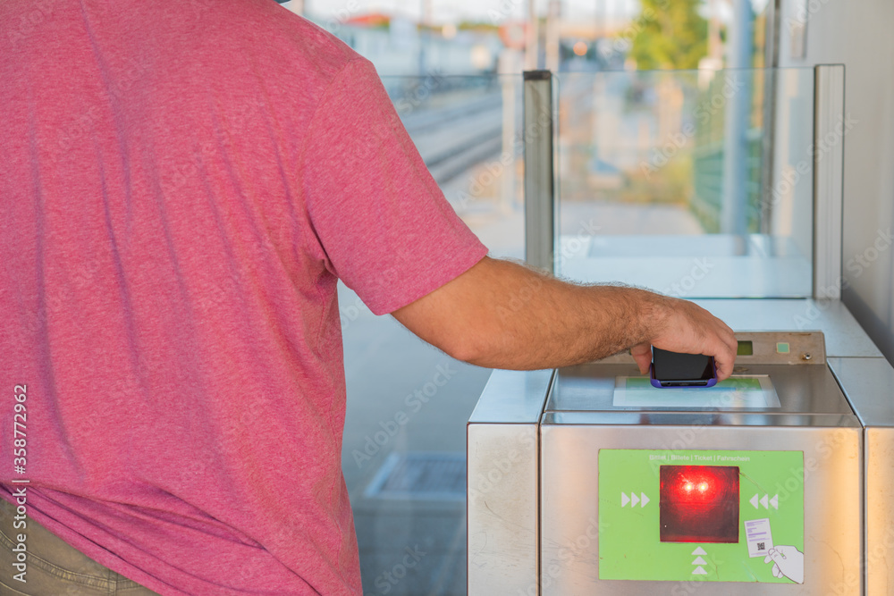 Public transport, young man paying train and metro ticket with his ...