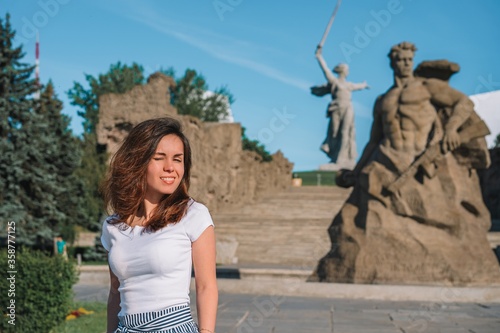 Russian girl patriot is proud of the victory and the country on the monument to the Motherland on Mamayev Kurgan in Volgograd