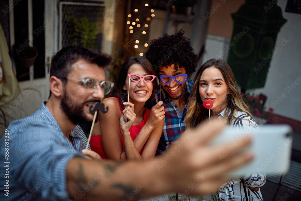 Friends with funny masks taking a sefie Friends with funny masks taking a sefie
