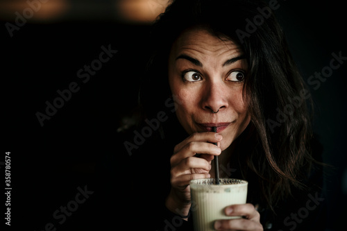 Europe, Germany, Berlin, beautiful woman is caffeinated by matcha latte.