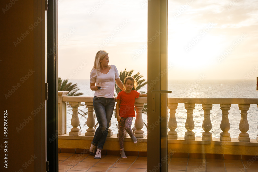 Woman near window facing the sunrise at morning Woman near window facing the sunrise at morning