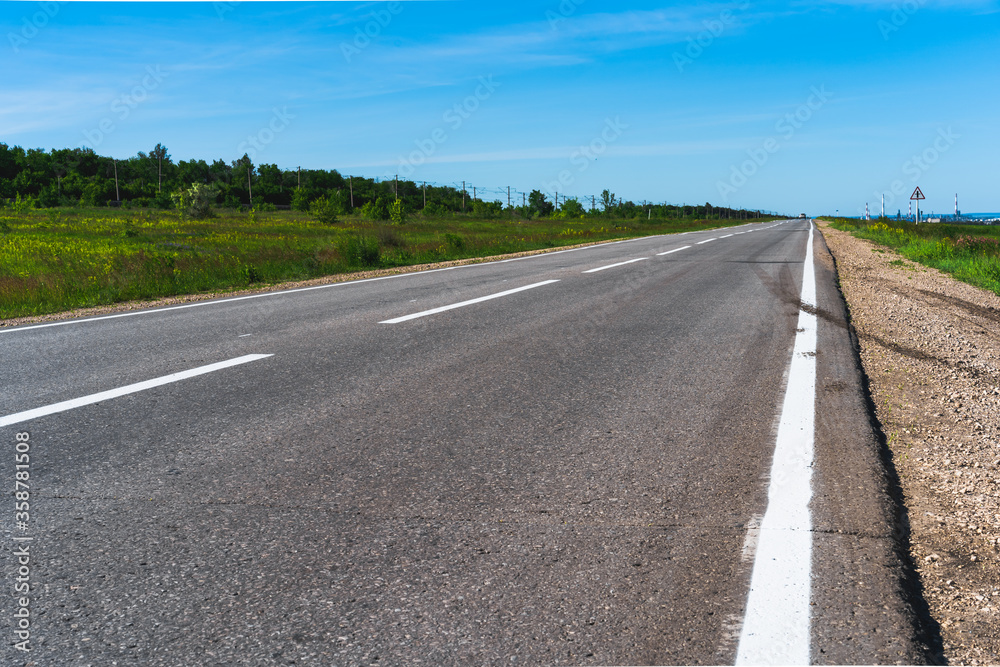 Panoramic photo of an empty highway with rural views, Russian nature