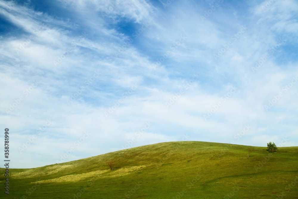 landscape with green hills and blue sky.