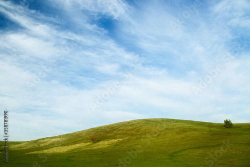 landscape with green hills and blue sky.