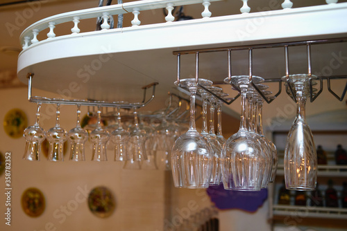 Sparkling wine glasses hanging in bar, copy space © mirage_studio