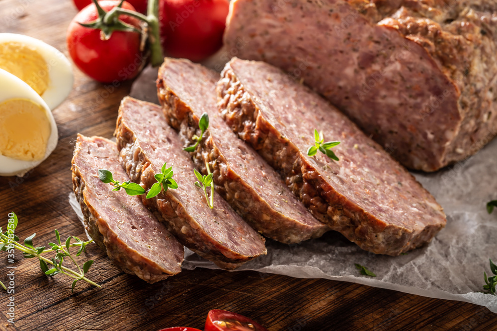 Homemade ground meatloaf with eggs tomatoes celery herbs and thyme