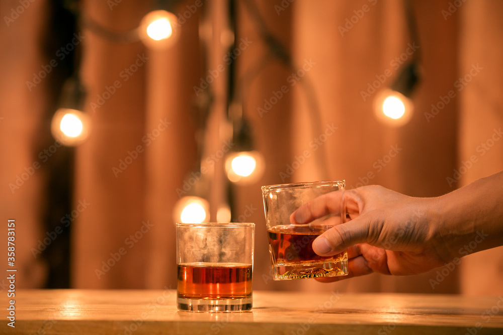 Barman pouring whiskey glass beautiful night.

L